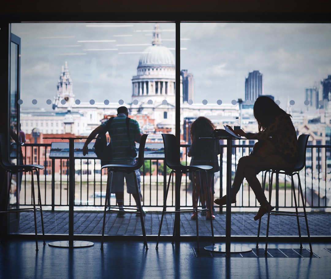 three-person-sitting-while-watching-washington-dc-capitol-tgo2abhgpma